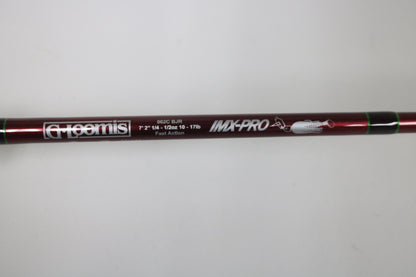 A close-up of a maroon G. Loomis IMX PRO 862C BJR 7’2” Medium Used Casting Rod in mint condition shows the label, specifications, brand logo, and a small fish graphic.