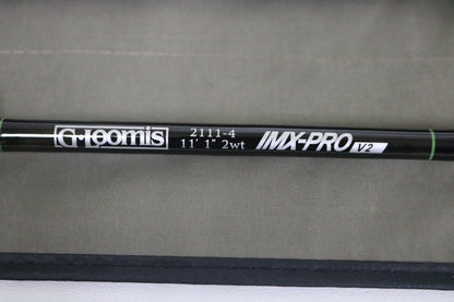 A close-up of a G. Loomis IMX-PRO V2 Shortspey 2111-4 11'1" #2 used fly rod in mint condition, set against a beige background—great for those interested in used gear or our Rod and Reel Trade-In Program.
