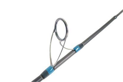 Close-up of a Megabass Cookai Gulf CKG-70M+S 7'0" spinning rod guide with a metal loop and blue-black attachments. The gray rod pops against the white background, ideal for our Rod and Reel Trade-In Program offering store credit for your used gear.