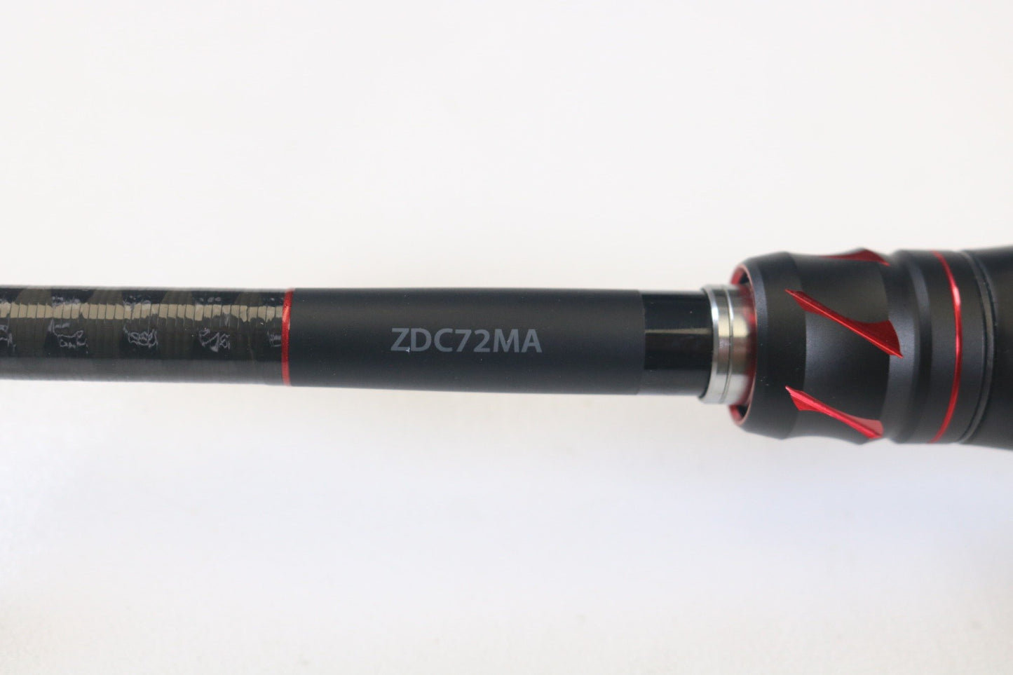 Close-up of a Shimano Zodias ZDC72MA 7'2" Medium Casting Rod featuring red accents on a sleek black shaft, set against a white background. Trade in your gear for possible store credit via our Rod and Reel Trade-In Program.
