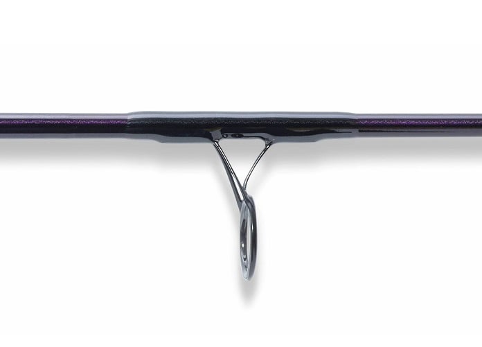 Close-up of a St. Croix Mojo Jig 6'6" Medium Spinning Rod (MJJS66MMF) guide, highlighting the ring and metallic frame on the dark, saltwater-ready rod. The plain white background emphasizes its premium St. Croix design.