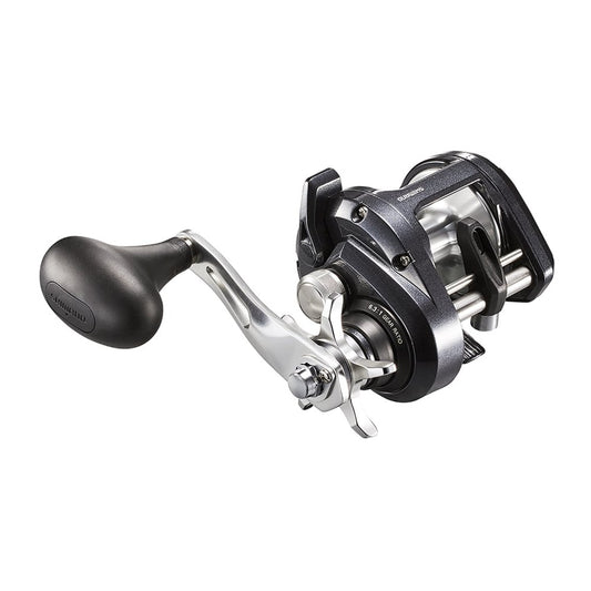 A close-up of the Shimano Tekota 500HGA 6.3:1 Casting Reel by Shimano shows its large handle, metallic parts, and open spool design with Coreprotect water resistance, isolated on a white background.