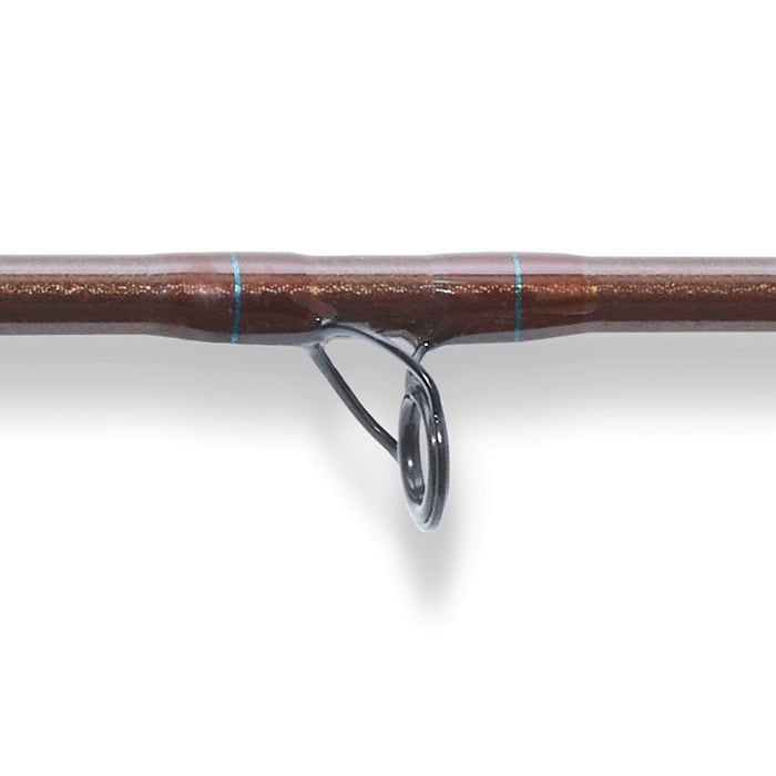 Close-up of the St. Croix Imperial USA 11'0" 6wt Fly Switch Rod (IU1106.4), showing a segment of its brown high-modulus graphite blank with blue accents and a metal line guide against a plain white background.