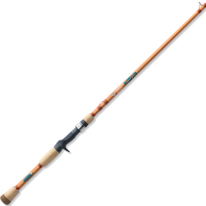 The St. Croix Legend Glass 7'4" Medium Heavy Casting Rod (LGC74MHM), featuring a cork handle, dark grip, orange-brown shaft, silver reel seat, and blue logo, is shown diagonally on a white background.