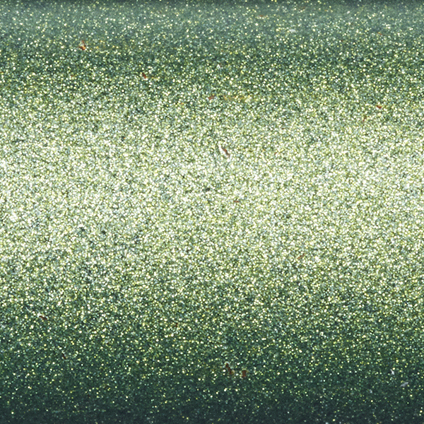 Close-up of a smooth green metallic surface with a glittery, sparkling texture—reflective of the advanced Fuji Torzite guides featured on the St. Croix Legend X 7'0" Medium Heavy Casting Rod (XLC70MHF).