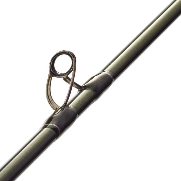 Close-up of the St. Croix Legend X 6'8" Medium Extra Fast Casting Rod (XLC68MXF) by St. Croix, highlighting a line guide with metal loop, advanced reinforcing technology, and metallic green finish against a white background.