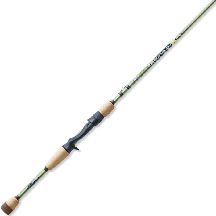 The St. Croix Legend X 7'4" Heavy Casting Rod (XLC74HF) features green finish, cork handles at both ends, a black reel seat grip, and Integrated Poly Curve Technology, shown against a white background.