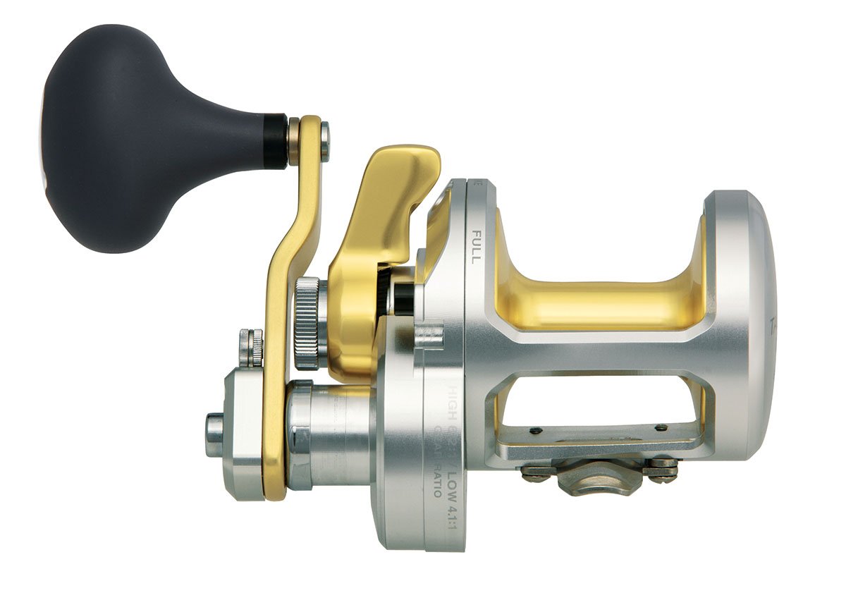 A close-up side view of the Shimano Talica TAC50II 2 Speed Lever Drag Reel shows its silver and gold details, black handle, and clearly labeled parts.