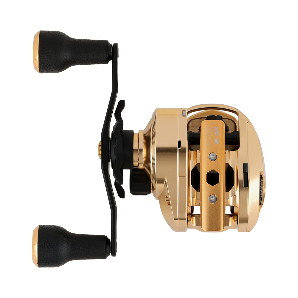 The Bates Fishing Co. GOAT SWM LE Knox Gold Casting Reel 5.2:1 RH features a gold and black design with two black handle grips, made from durable 6061-T6 aluminum, and is shown from the side on a white background.