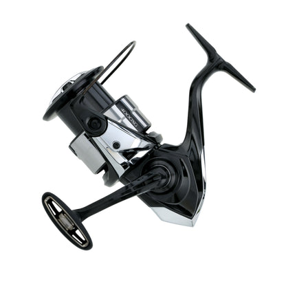A sleek Shimano Vanquish Spinning Reel 4000XGC 6.2:1 (VQ4000XGC) in black and silver, featuring MagnumLite technology, is shown angled against a white background, highlighting its handle and spool.