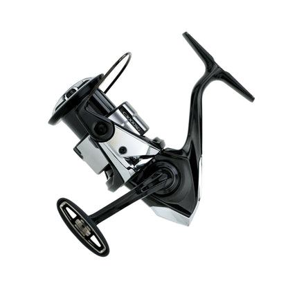 A close-up of the Shimano Vanquish Spinning Reel C3000XG 6.4:1 by Shimano, a sleek black and silver ultra-performance spinning reel with handle, spool, and bail arm, displayed against a white background.