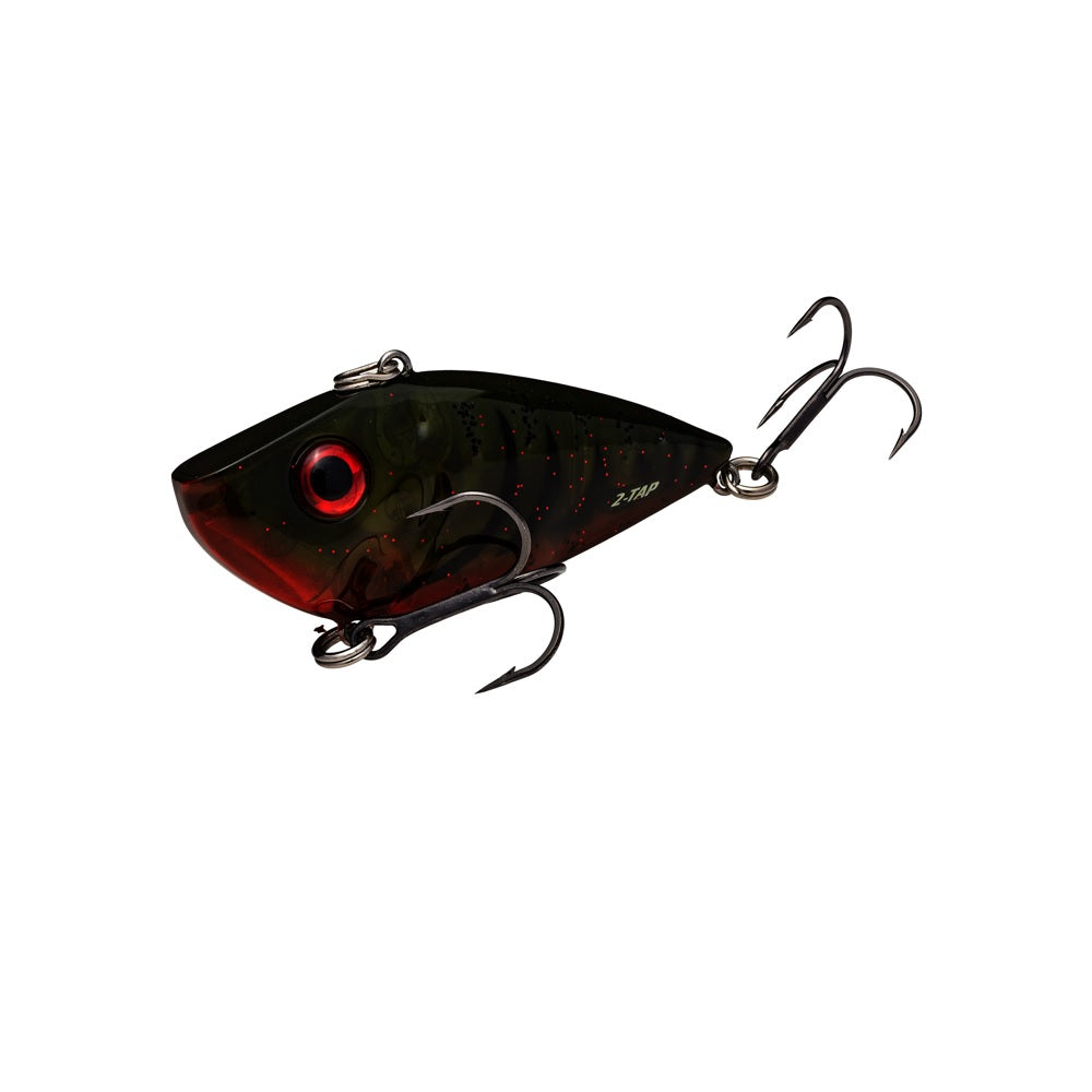 The Strike King Red Eye Shad Tungsten 2 Tap Lipless Crankbait 1/2oz is a small, dark-colored, fish-shaped lure with two treble hooks, a red eye, and a slightly translucent body showing red and green hues.