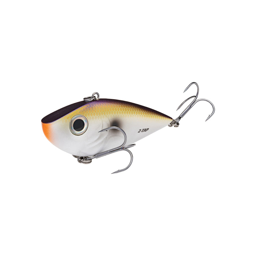 The Strike King Red Eye Shad Tungsten 2 Tap Lipless Crankbait 3/4oz features a silver body, dark top, yellow sides, orange near the mouth, two large treble hooks, and a painted eye for lifelike appeal.