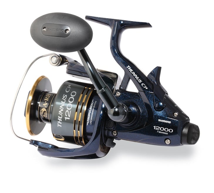 The Shimano Thunnus 12000CI4 Saltwater Spinning Reel by Shimano is lightweight, with a metallic blue and black body, gold accents, and visible branding on the spool and side.