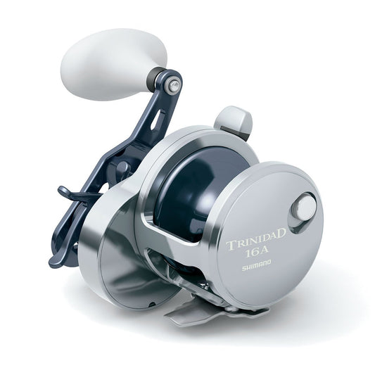 The Shimano Trinidad 16A Conventional Reel by Shimano boasts a sleek silver finish and large round handle, making it ideal for saltwater anglers seeking dependable performance. Displayed on a white background.