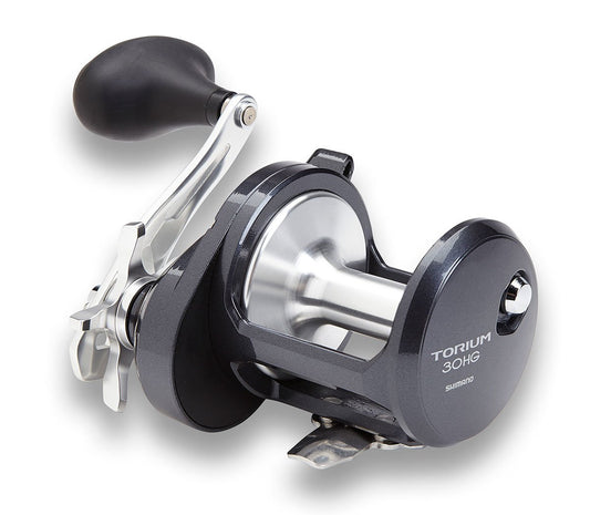 A close-up of a Shimano Torium 30HGA Star Drag Fishing Reel, finished in metallic silver and black with a large handle and sturdy build, from Shimano, displayed on a white background.