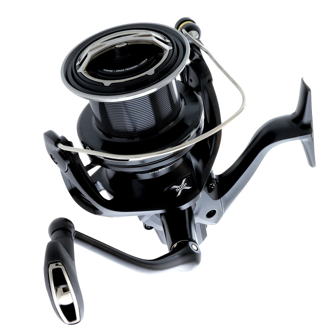 A close-up of the Shimano Ultegra XTD Surf Reel ULT5500XTD features a sleek black design with a metal handle and spool, delivering long-casting performance against a white background.