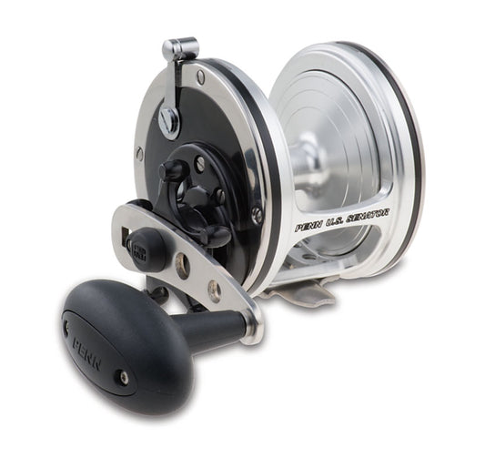 The Penn US Senator Conventional Fishing Reel US113W, in silver and black, is shown from the side with its large handle, visible gears and spool. The "PENN" brand name appears on the handle and side plate. Made in USA.